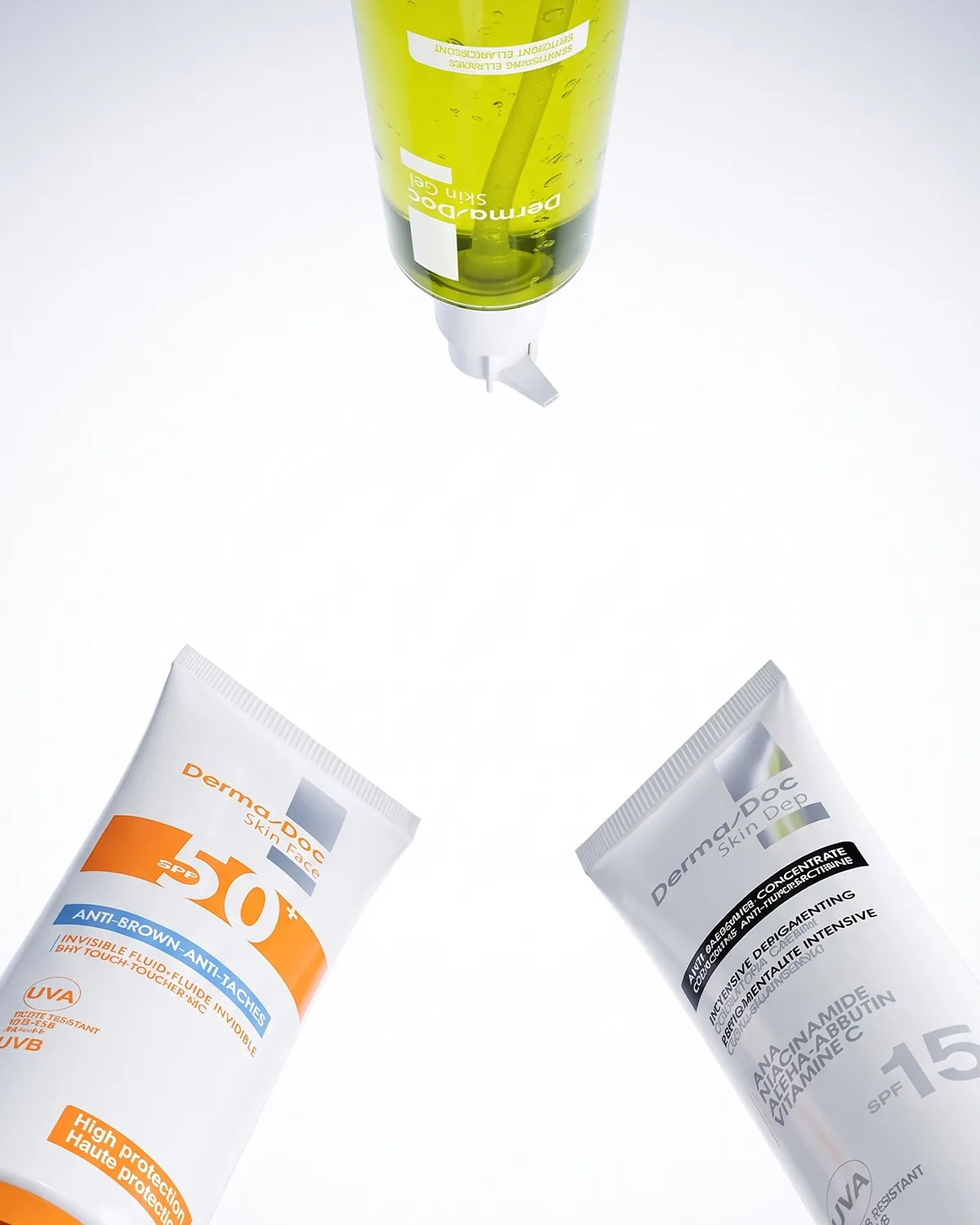 Écran solaire SPF 50+, soin dépigmentant et gel nettoyant DermaDoc sur fond clair.